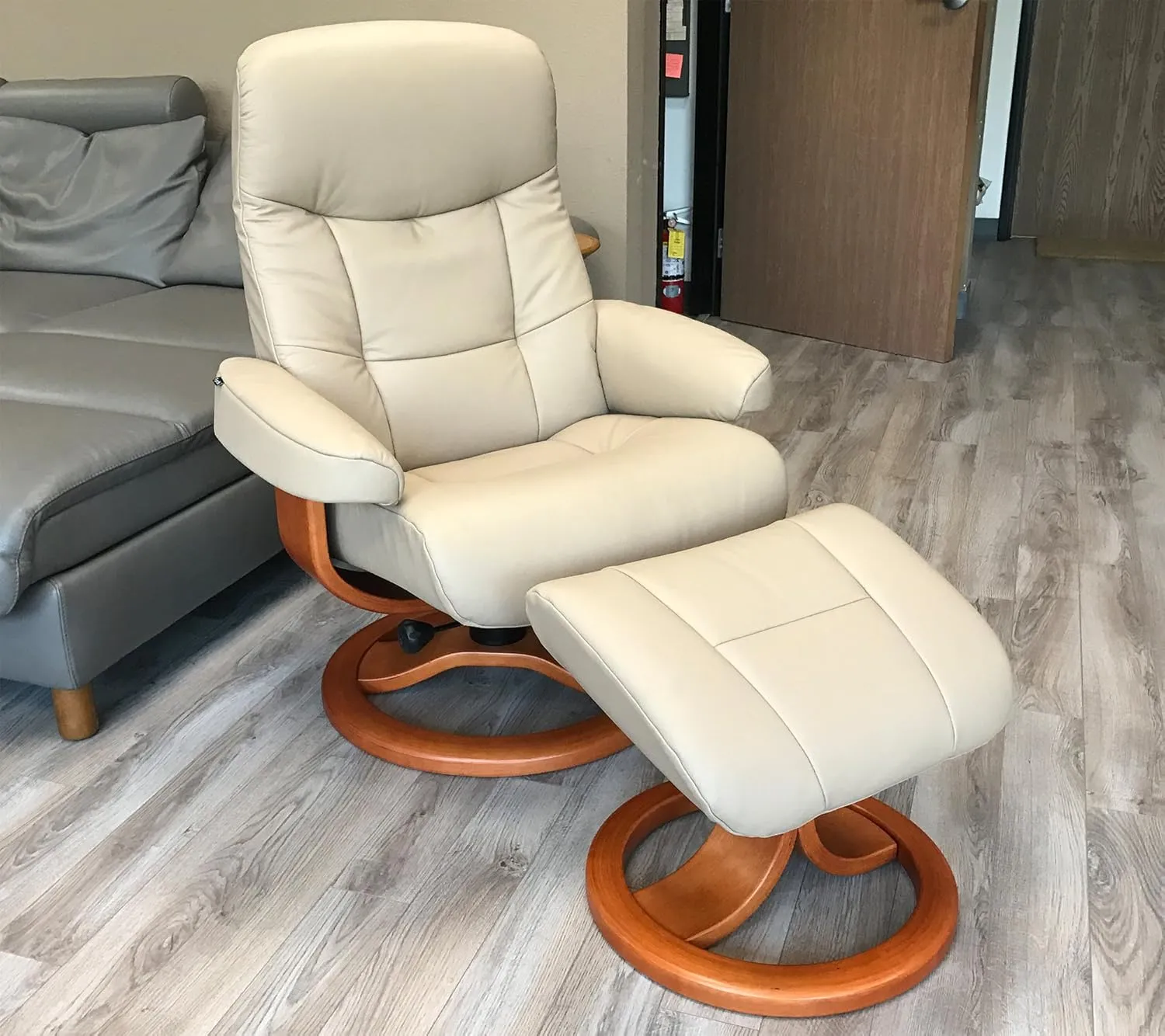 Small Leather Ergonomic Swivel Recliner Chair with Ottoman in Sandel NL 121 Nordic Line Leather with a Charcoal Wood Stain Base