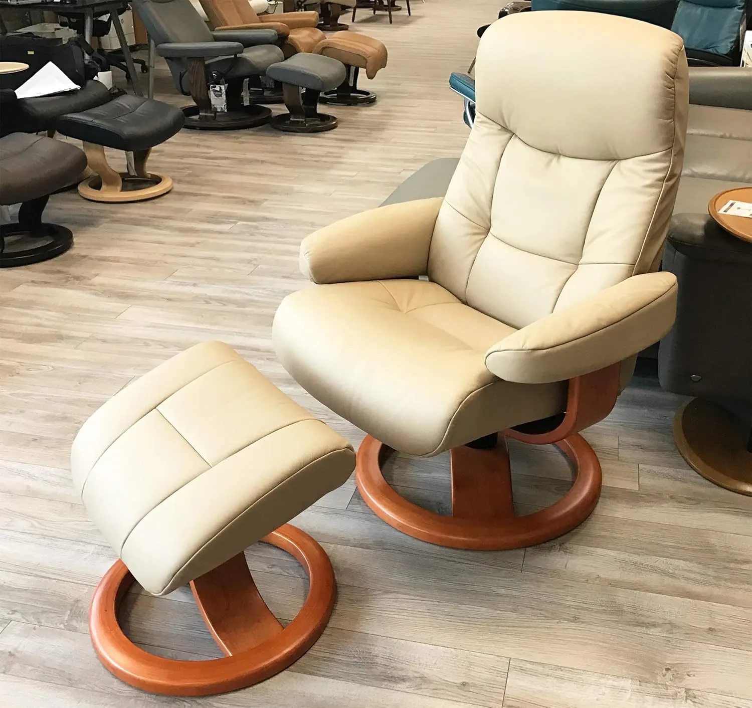 Small Leather Ergonomic Swivel Recliner Chair with Ottoman in Sandel NL 121 Nordic Line Leather with a Charcoal Wood Stain Base